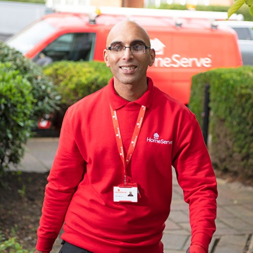HomeServe engineer arriving at house HomeServe engineer outside home with toolkit