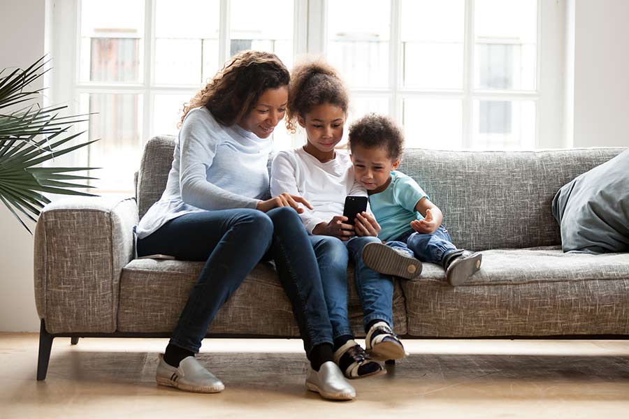 Family sitting happy on the sofa