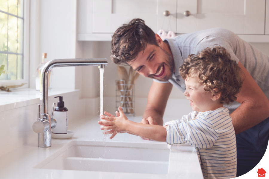 father washing son's hands in the kitchen sink - How to change a kitchen tap