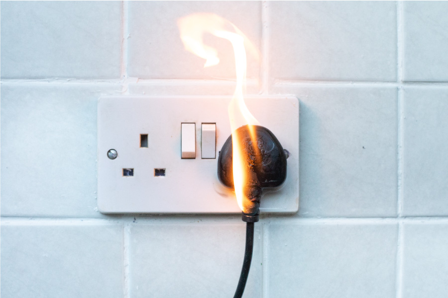 An electrical fire coming from a plug socket 