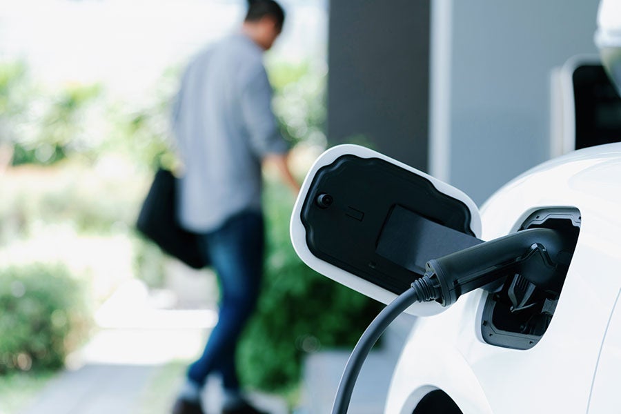 An electric car charging at home via an untethered charger