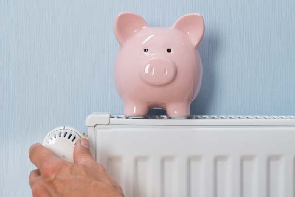 A radiator being turned down with ceramic piggy bank on top of it