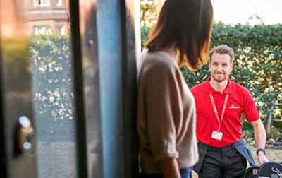 A HomeServe engineer walking towards a customer's home